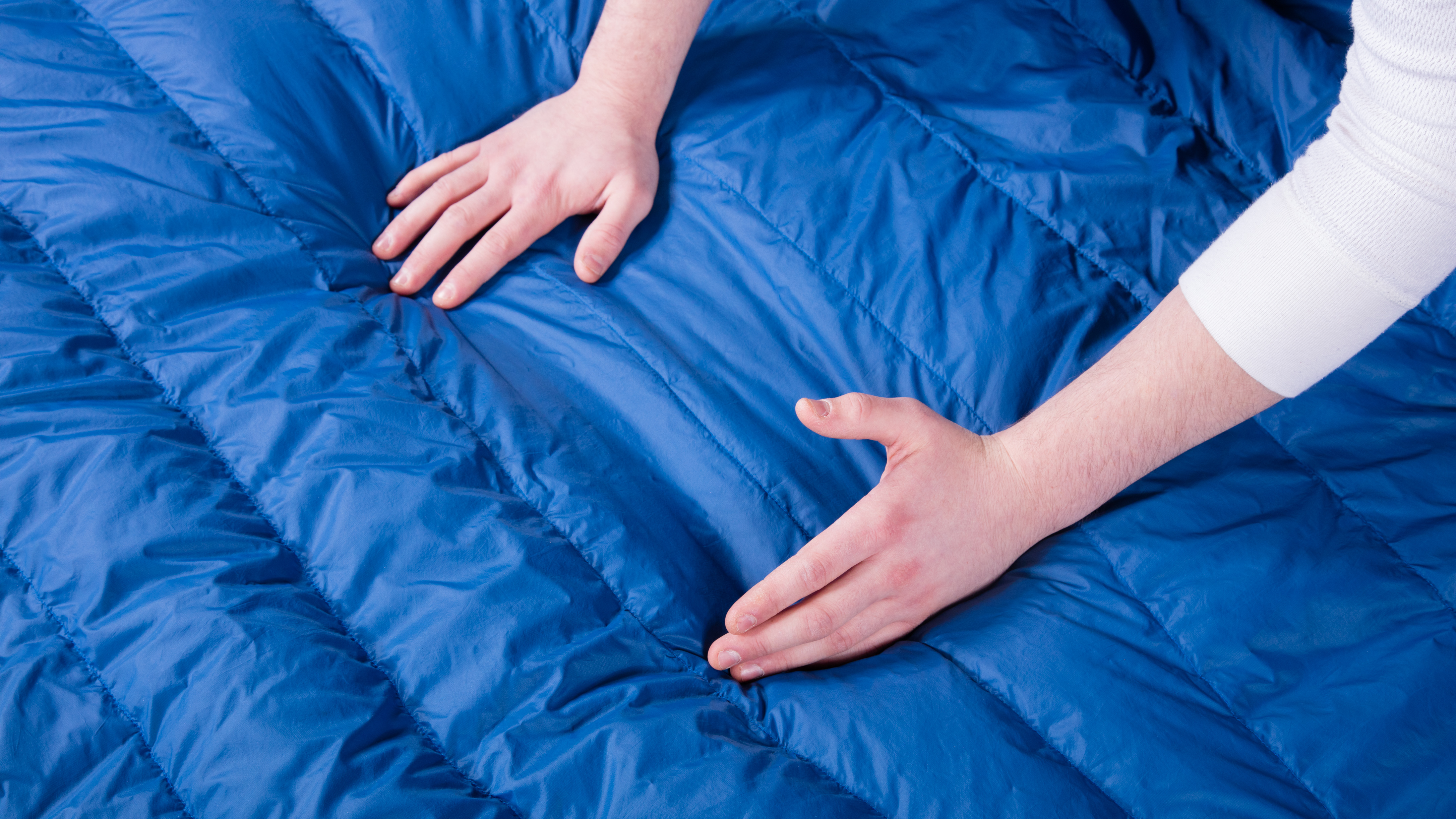 How do you evenly redistribute the down in a sleeping bag?